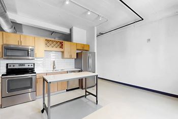 A kitchen with a stove top oven and microwave.